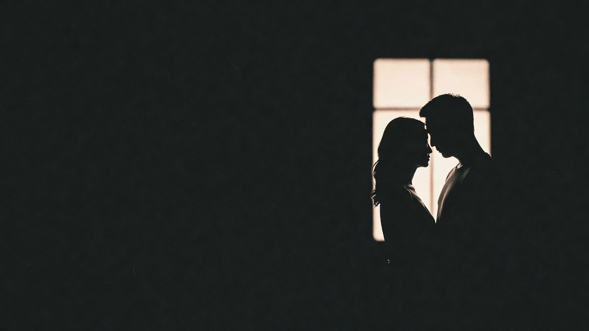 A couple close together, foreheads touching